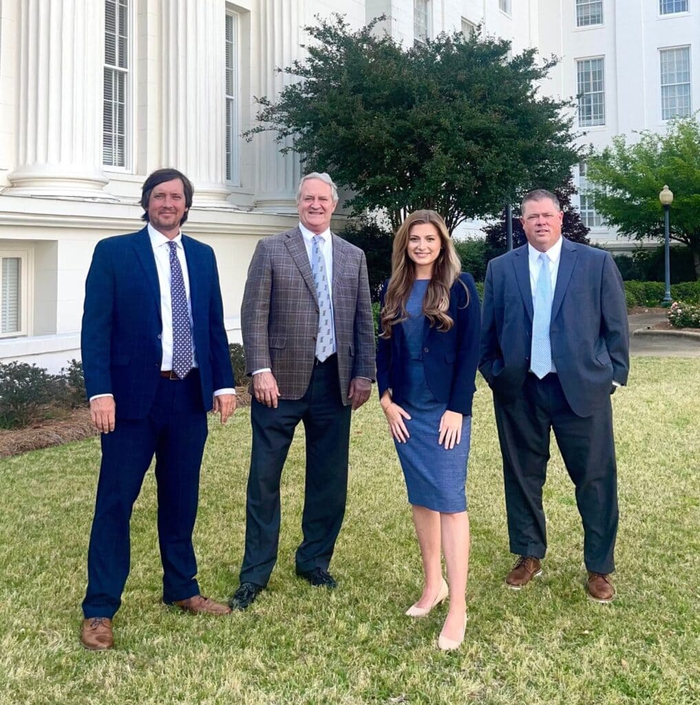 Trusted Lawyers in Montgomery, AL 1 a group of people standing in front of a building