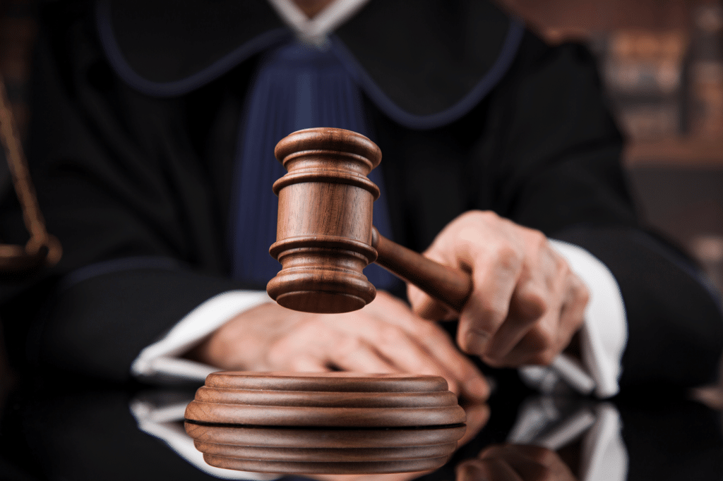 a judge's hand hitting a gavel